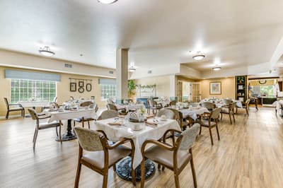 Dining room setup with tables and chairs.