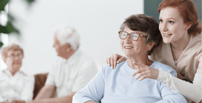 Senior resident smiling with staff support