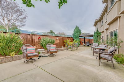 Outdoor seating area with plants and furniture