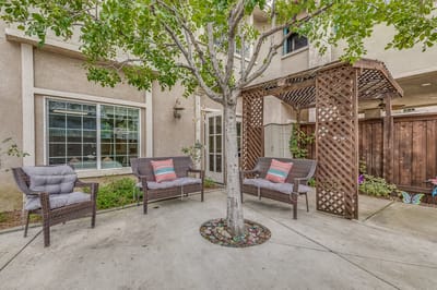 Outdoor seating area with plants and decor.