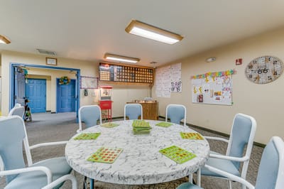 Activity room with a round table and game supplies.