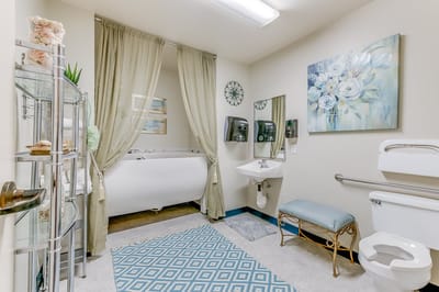 Elegant bathroom with soft decor and amenities.