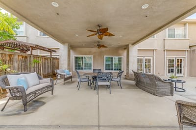 Outdoor seating area with fans and furnishings
