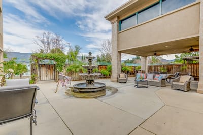 Outdoor patio area with fountain and seating