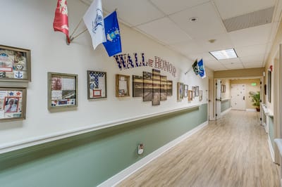 Hallway with framed pictures and decorative flags