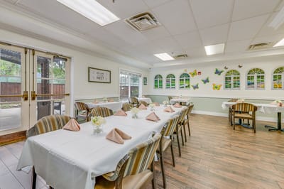 Dining area with decorated tables and chairs.