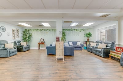 Cozy common area with seating and plants.