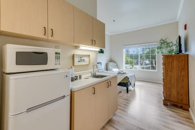 Private resident room with kitchenette and seating area