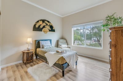 Cozy resident room with natural light and decor.