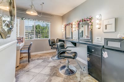 Interior view of a salon area with styling chairs and mirrors.