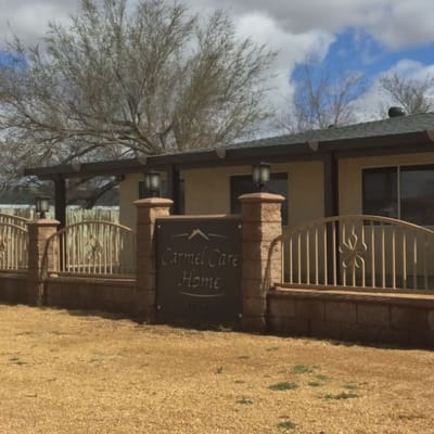 Exterior view of Carmel Care Home sign and building