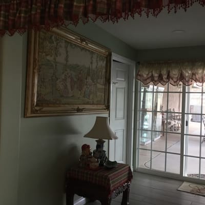 Decorative interior with artwork and lamp.