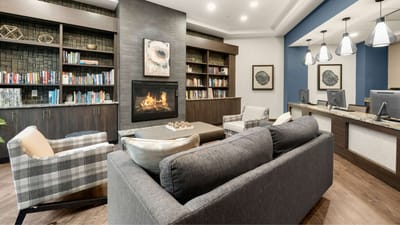 Cozy common area with bookshelves and a fireplace