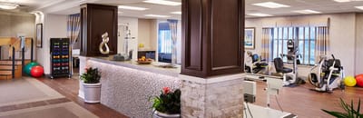 Well-equipped fitness room with exercise equipment and decor