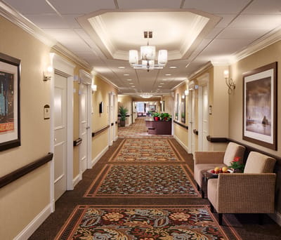 Well-lit hallway with seating and artwork