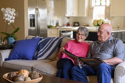 Residents enjoying a photo book in a cozy living room