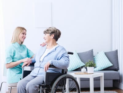 Caregiver interacting with a resident in a bright room