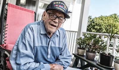 Elderly veteran enjoying a sunny day on the porch