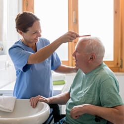 All Ways Caring HomeCare – Missoula, home care in Missoula, MT — Caregiver assisting elderly man in a bright room