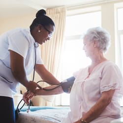 All Ways Caring HomeCare – Missoula, home care in Missoula, MT — Nurse checking blood pressure of elderly patient at home