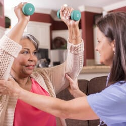All Ways Caring HomeCare – Missoula, home care in Missoula, MT — Senior resident exercising with a caregiver using dumbbells