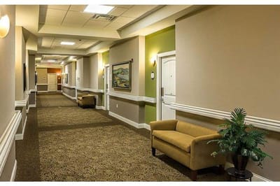Well-lit corridor with seating and decor