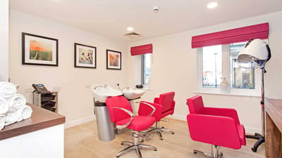 A vibrant salon area with styling chairs and sinks