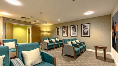 Lounge area with seating and framed photos on the wall