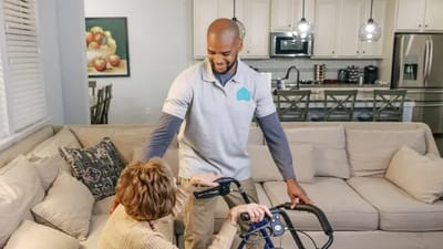 Caregiver assisting a resident in a cozy living room
