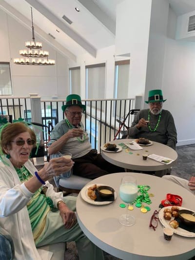 Residents enjoying St. Patrick's Day celebration with snacks