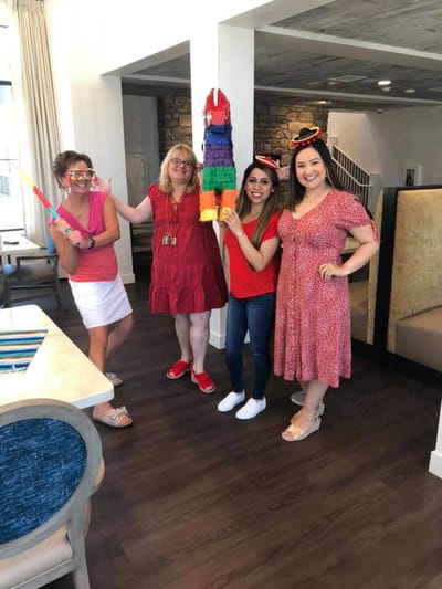Staff and residents celebrating with a piñata indoors