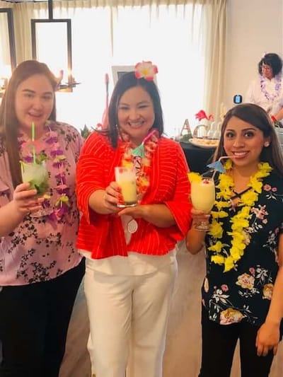 Staff celebrating with drinks at a festive event