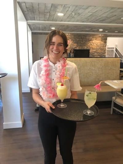 Staff member serving drinks in a common area