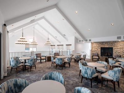 Bright common area with seating and a fireplace