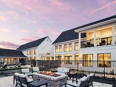 Exterior view of a senior living facility at sunset