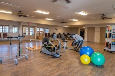 Interior view of a therapy gym with exercise equipment