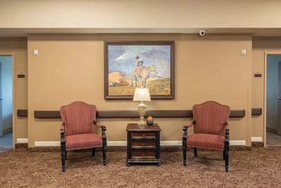 Cozy seating area with two chairs and a lamp