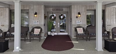 Entrance of Arbor North Living Center with seating area