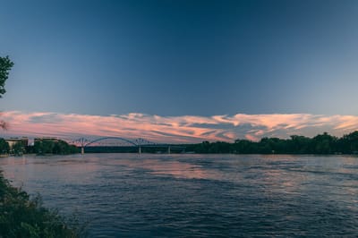 Scenic view of a river at sunset with clouds.
