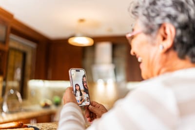 Senior woman enjoying a video call in a kitchen