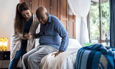 Caregiver assisting a resident in a room