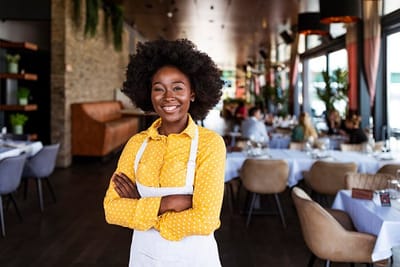 Smiling staff member in a dining area
