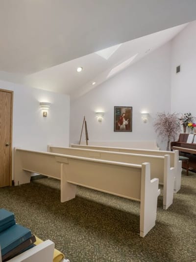 Interior view of a quiet chapel with pews.