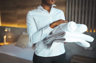 Staff member holding clean towels