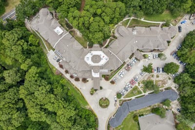 Aerial view of the facility surrounded by trees.