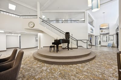 Lobby area with a piano and seating