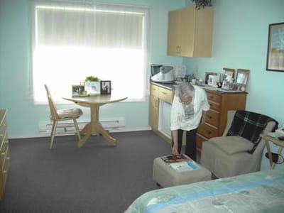 Resident adjusting items in their private room.