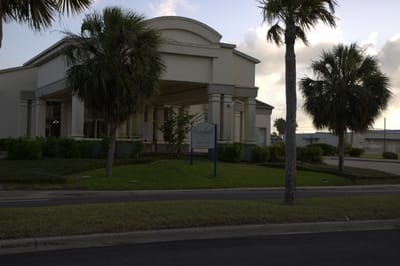 Exterior view of The Waterford building with palm trees
