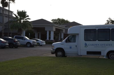Exterior view of assisted living facility with shuttle bus