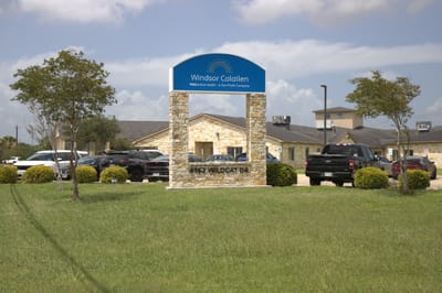 Outside view of Windsor Calallen facility with sign and parking area